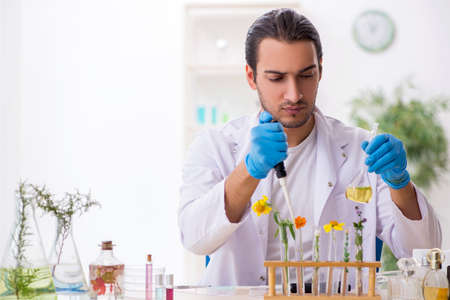 Young male chemist in perfume synthesis conceptの写真素材