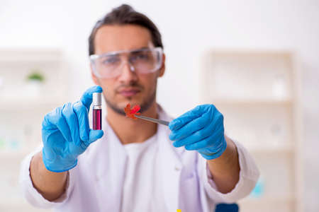 Young male chemist in perfume synthesis concept