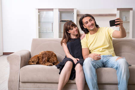 Young couple with cocker spaniel dogの写真素材