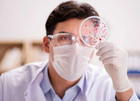 Male doctor working in the lab on virus vaccineの写真素材