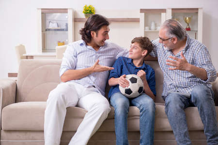 Boy and his father and his grandfother indoor