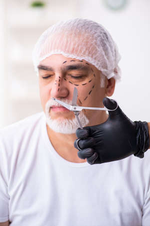 Old man visiting male doctor for plastic surgeryの写真素材