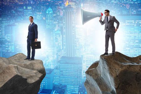The businessman shouting with loudspeaker at others