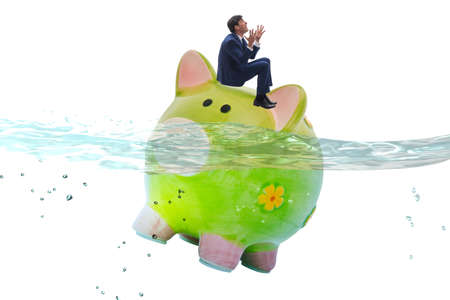 Businessman in debt concept with piggybank