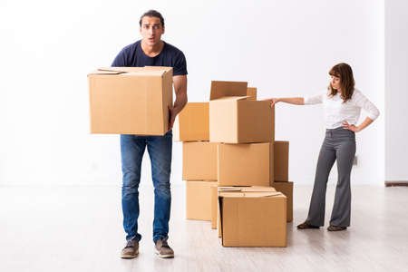 Young pair and many boxes in divorce settlement concept