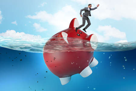 The businessman in debt concept with piggybankの写真素材