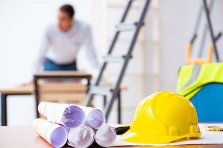 Young male architect working indoors on project