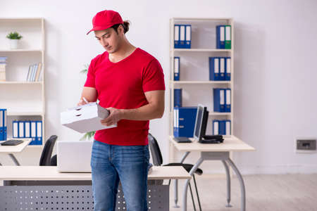Young male courier delivering pizza to the office