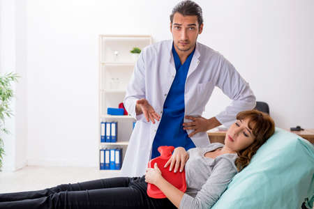 Young pregnant woman visiting male doctor gastroenterologist