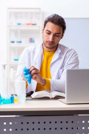 Young male chemist student preparing for examの写真素材