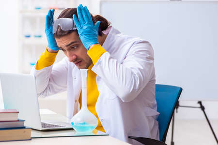 Young male chemist student preparing for examの写真素材
