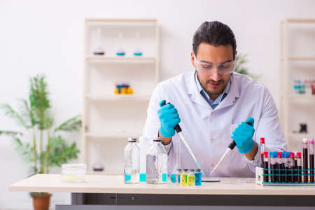Young male chemist working in the labの写真素材