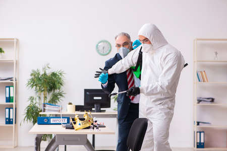 Old employee and young contractor in coronavirus conceptの写真素材