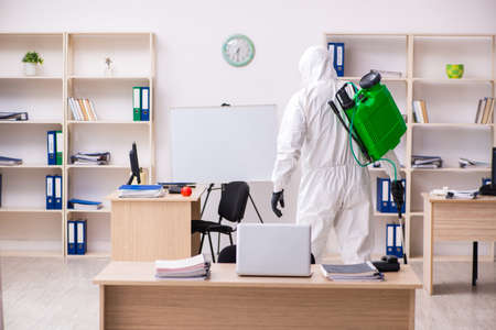 Contractor disinfecting office for COVID-19 coronavirusの写真素材