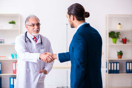 Male doctor and businessman discussing medical projectの写真素材