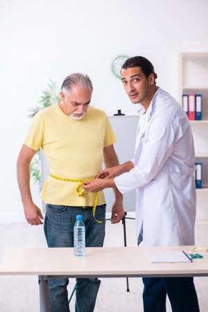 Doctor dietician giving advices to fat overweight patientの写真素材