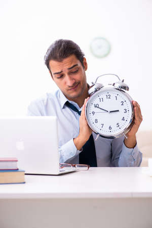 Young male employee working from houseの写真素材