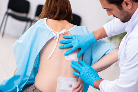 Injured young woman visiting male doctor