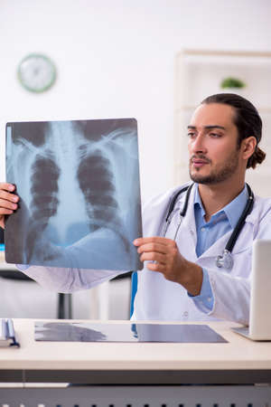 Young handsome male doctor working in the clinic