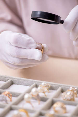 Old male jeweler at workshopの写真素材