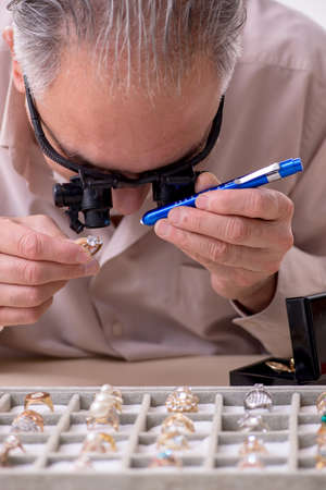 Old male jeweler at workshop