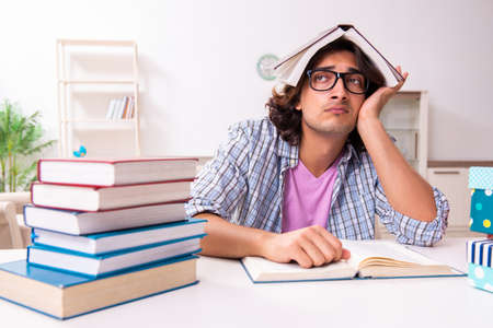 Young male student preparing for exams during Christmasの写真素材