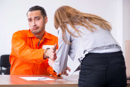 Young man meeting with advocate in pre-trial detentionの写真素材