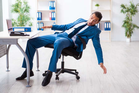 Young male employee in work accident conceptの写真素材