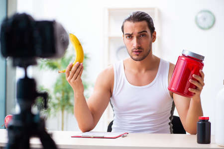 Young male blogger in dieting conceptの写真素材