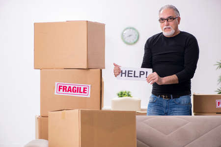 Old male professional mover doing home relocation