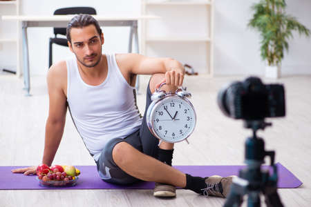 Young male blogger in dieting conceptの写真素材