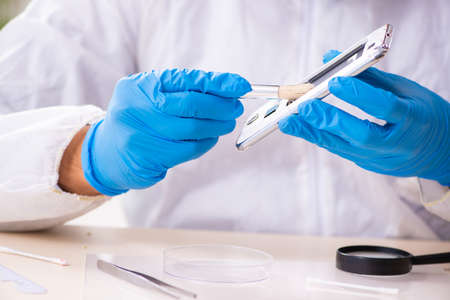 Male expert criminologist working in the lab for evidence
