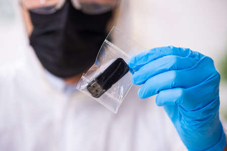 Male expert criminologist working in the lab for evidence