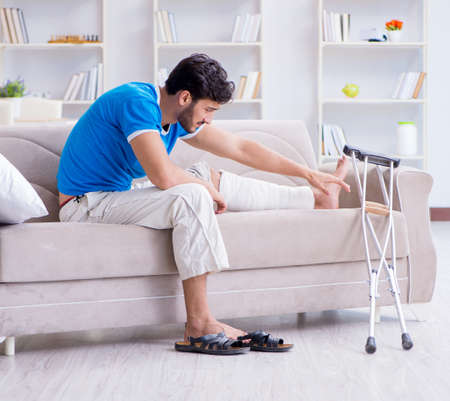 The injured young man recovering at homeの写真素材