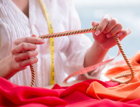 Woman tailor working on new dress designs