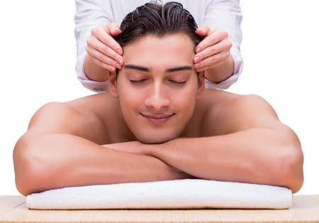 Handsome man during spa massaging sessionの写真素材