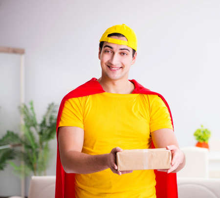 Superhero delivery guy with boxの写真素材