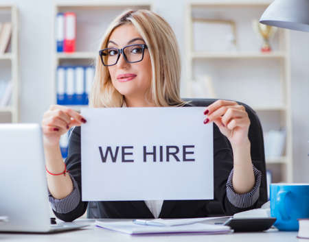 Young businesswoman with message in the officeの写真素材