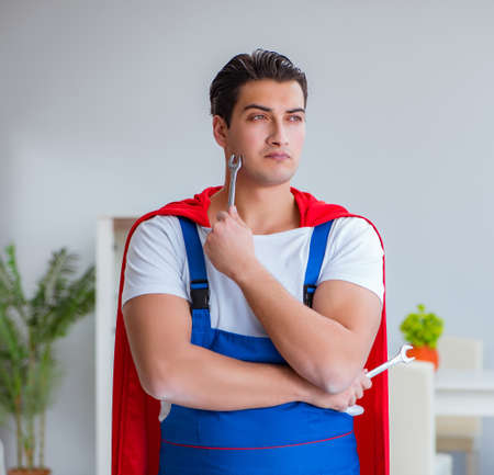 Super hero repairman working at homeの写真素材
