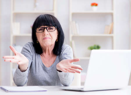 Senior woman struggling at computer