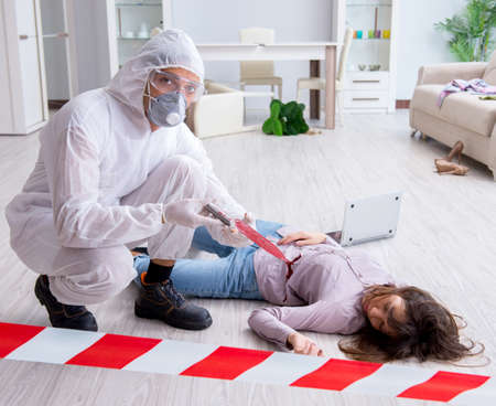 Forensic investigator at the crime scene investigating woman mur