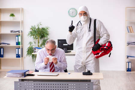Old employee catching coronavirus at workplaceの写真素材