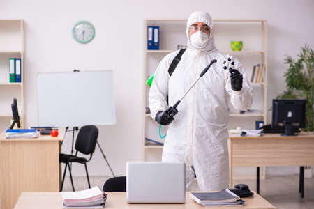 Contractor disinfecting office for COVID-19 coronavirusの写真素材