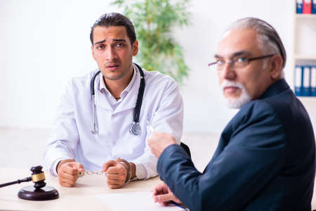 Male doctor in courthouse meeting with lawyerの写真素材