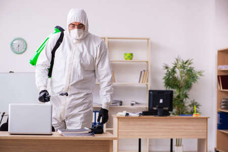 Contractor disinfecting office for COVID-19 coronavirusの写真素材
