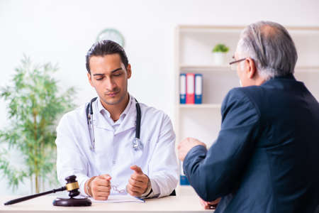 Male doctor in courthouse meeting with lawyerの写真素材