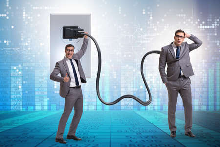 Businessman being powered by electricity and plugの写真素材