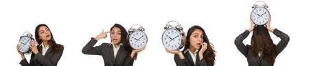 Businesswoman with clock missing her deadlinesの写真素材