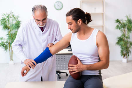 Young male patient visiting experienced doctorの写真素材