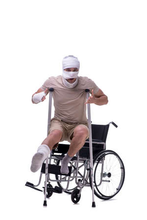 Injured man in wheel-chair isolated on whiteの写真素材